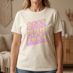 Person wearing a natural t-shirt with 'BEST MUM EVER' in purple and yellow.