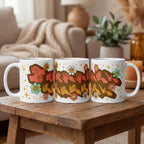 Three mugs with colorful designs on a wooden table in a cozy living room setting.
