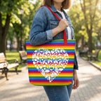 Person holding a rainbow tote bag with a heart design in a park