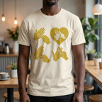 Person wearing a beige t-shirt with gold fingerspelling design in a casual setting
