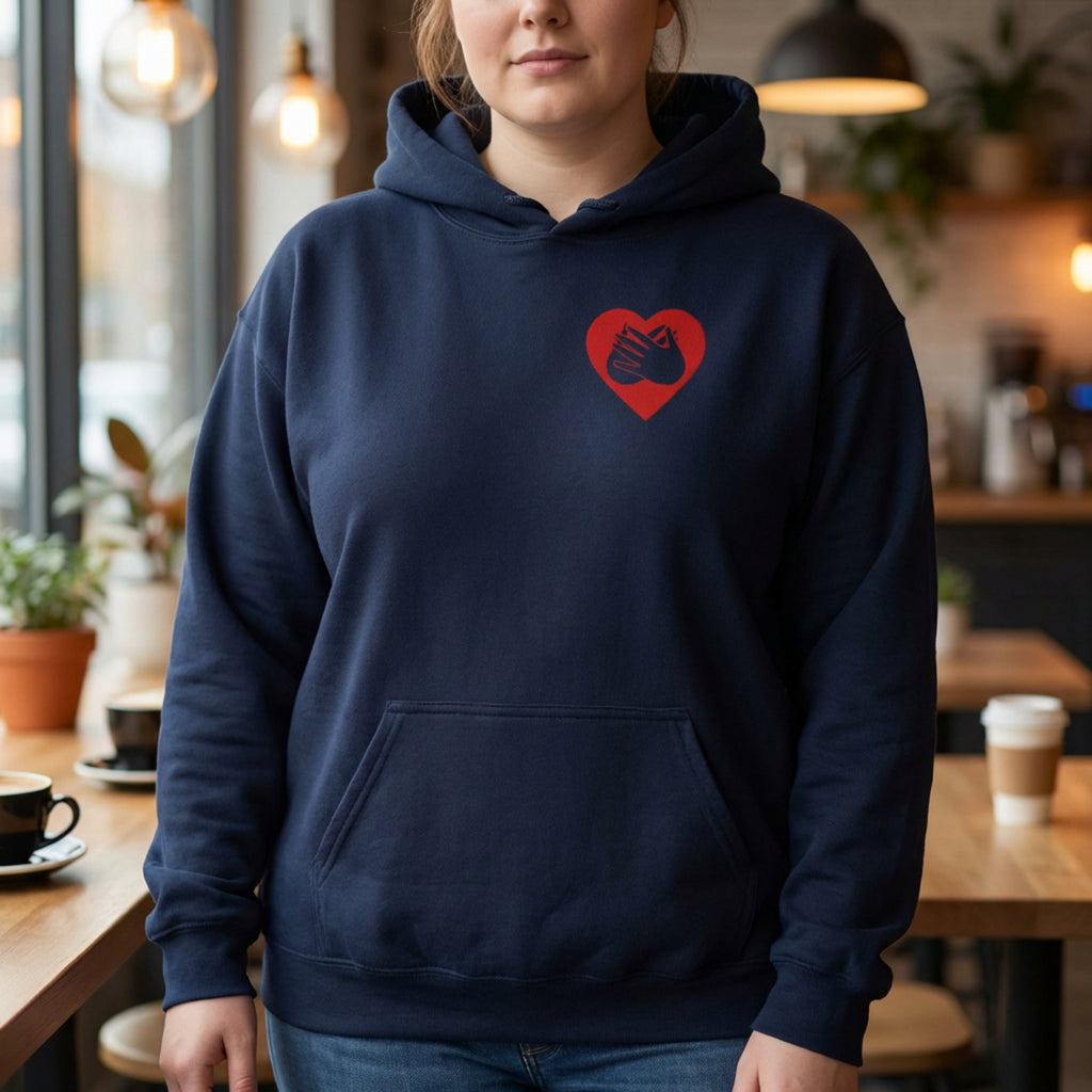 Person wearing a navy hoodie with a red heart design in a casual setting.
