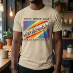 A person wearing a sand  t-shirt with pride rainbow spectrum of colours with the word Equality through the centre in BSL fingerspelling font