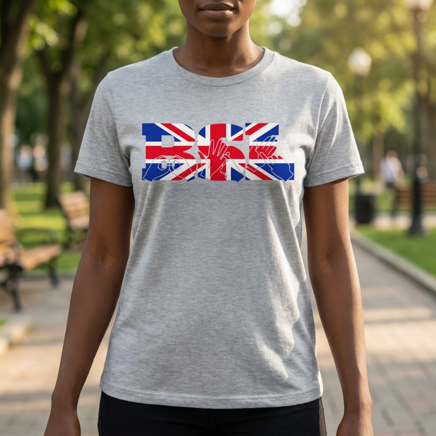 Person wearing a grey t-shirt with a Union Flag design in a park setting