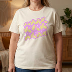 Person wearing a natural t-shirt with a purple and yellow graphic design in a room.