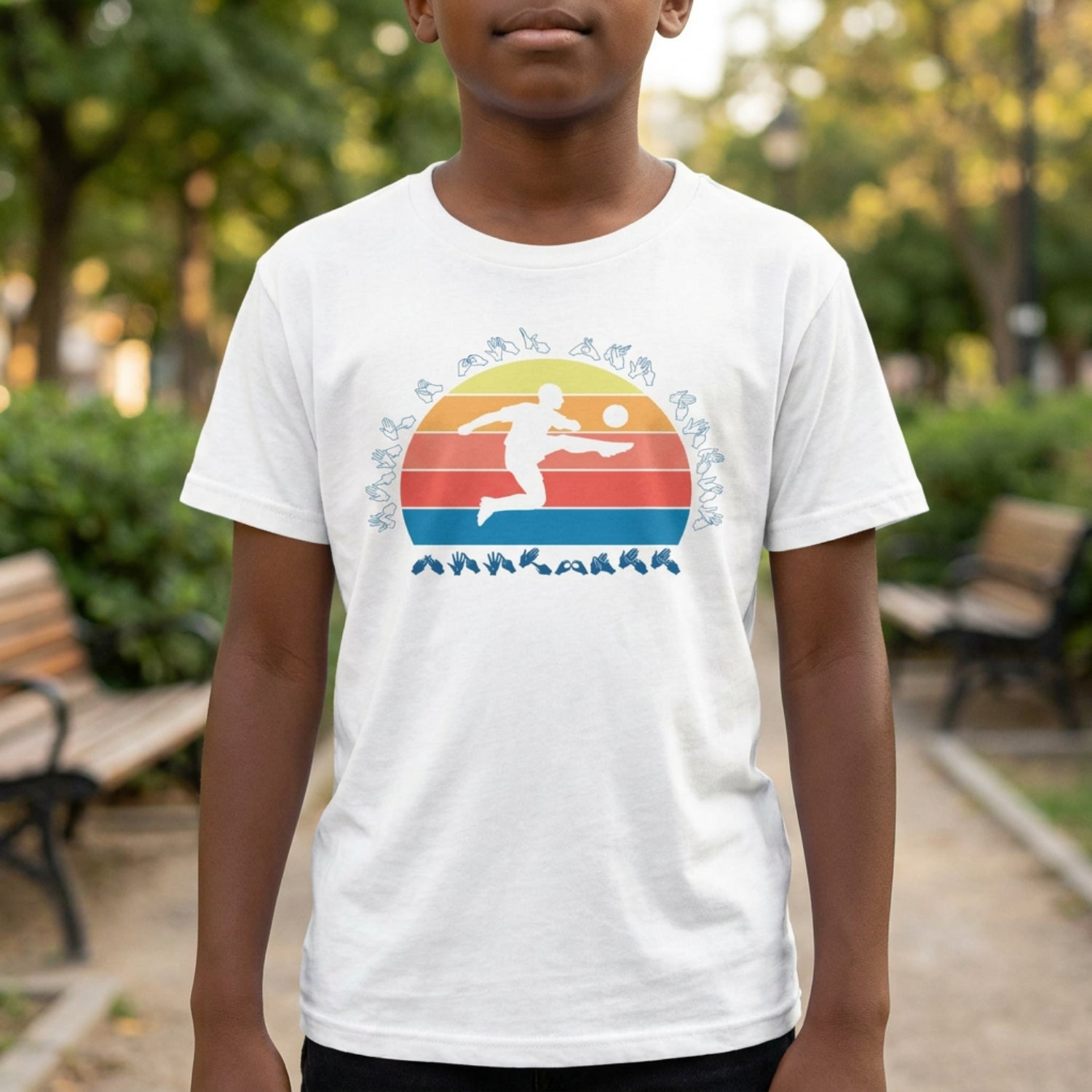 Person wearing a white t-shirt with a colorful graphic design outdoors.