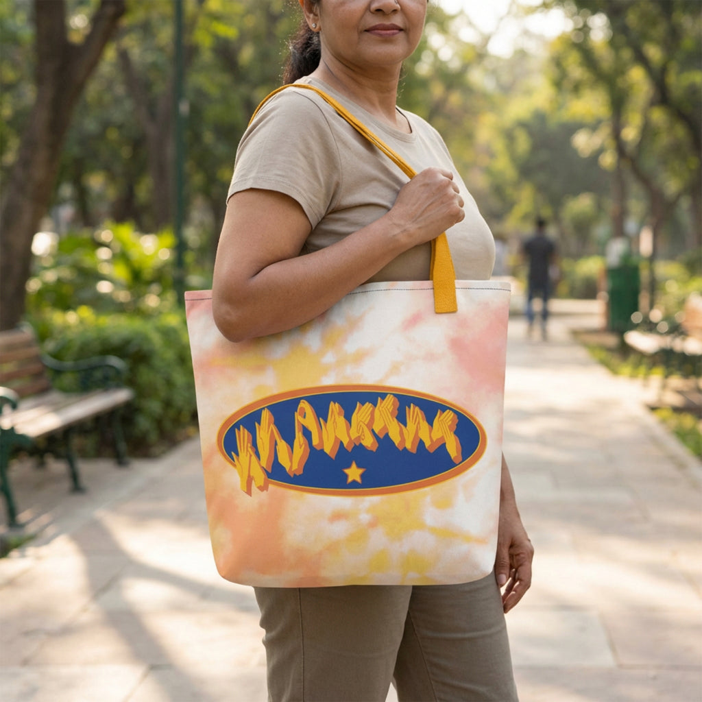 Woman holding a tie-dye tote bag with a logo in a park
