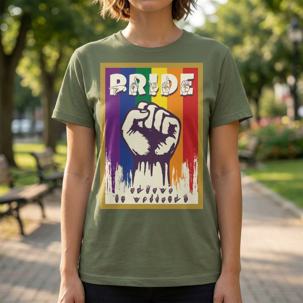 Person wearing a green t-shirt with a rainbow-themed design featuring a raised fist and the word 'PRIDE' in ASL fingerspelling.