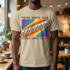 A person wearing a sand  t-shirt with pride rainbow spectrum of colours with the word Equality through the centre in ASL fingerspelling font