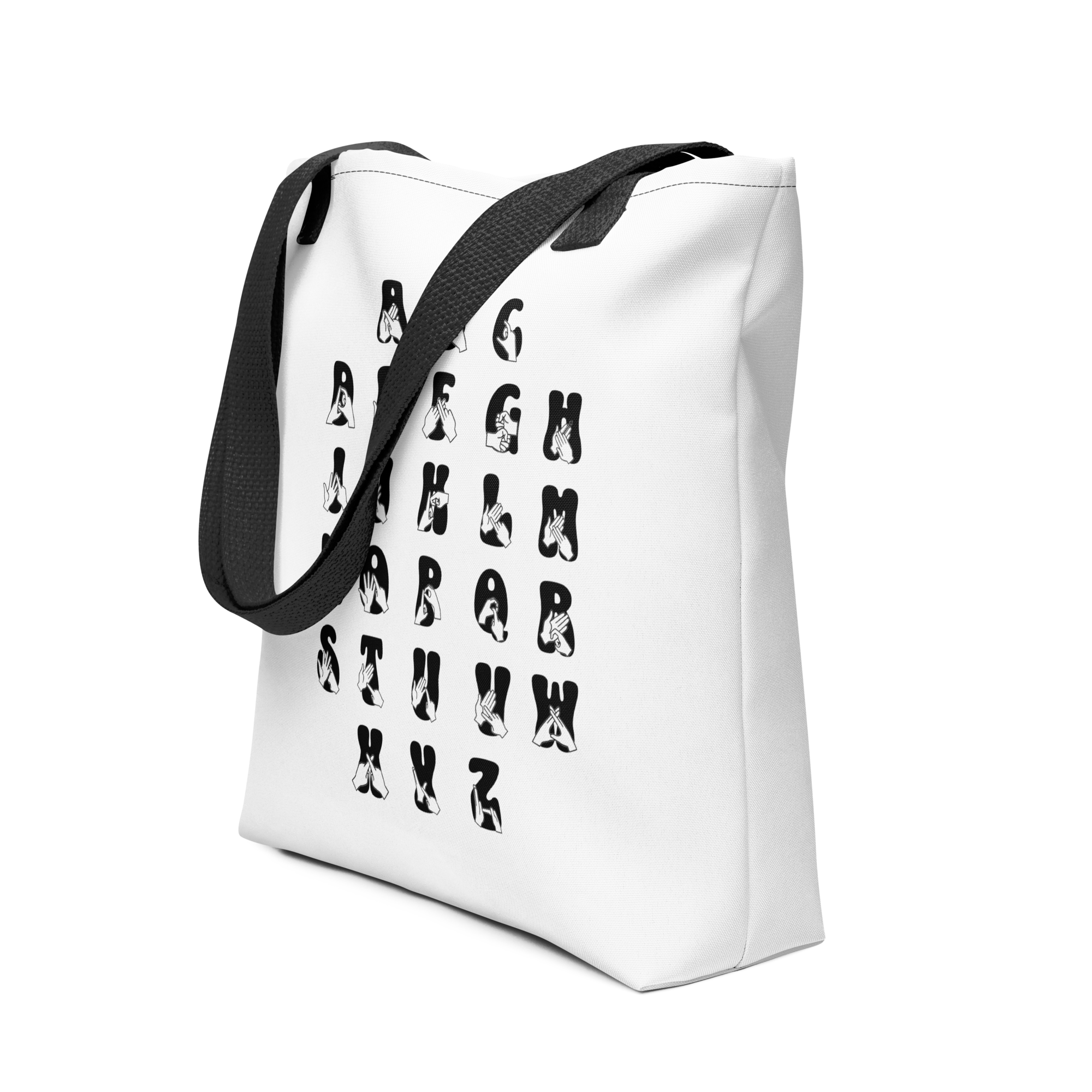 Angled view of White Tote Bag with a black handle showing BSL Alphabet - Black Fingerspelling & Text