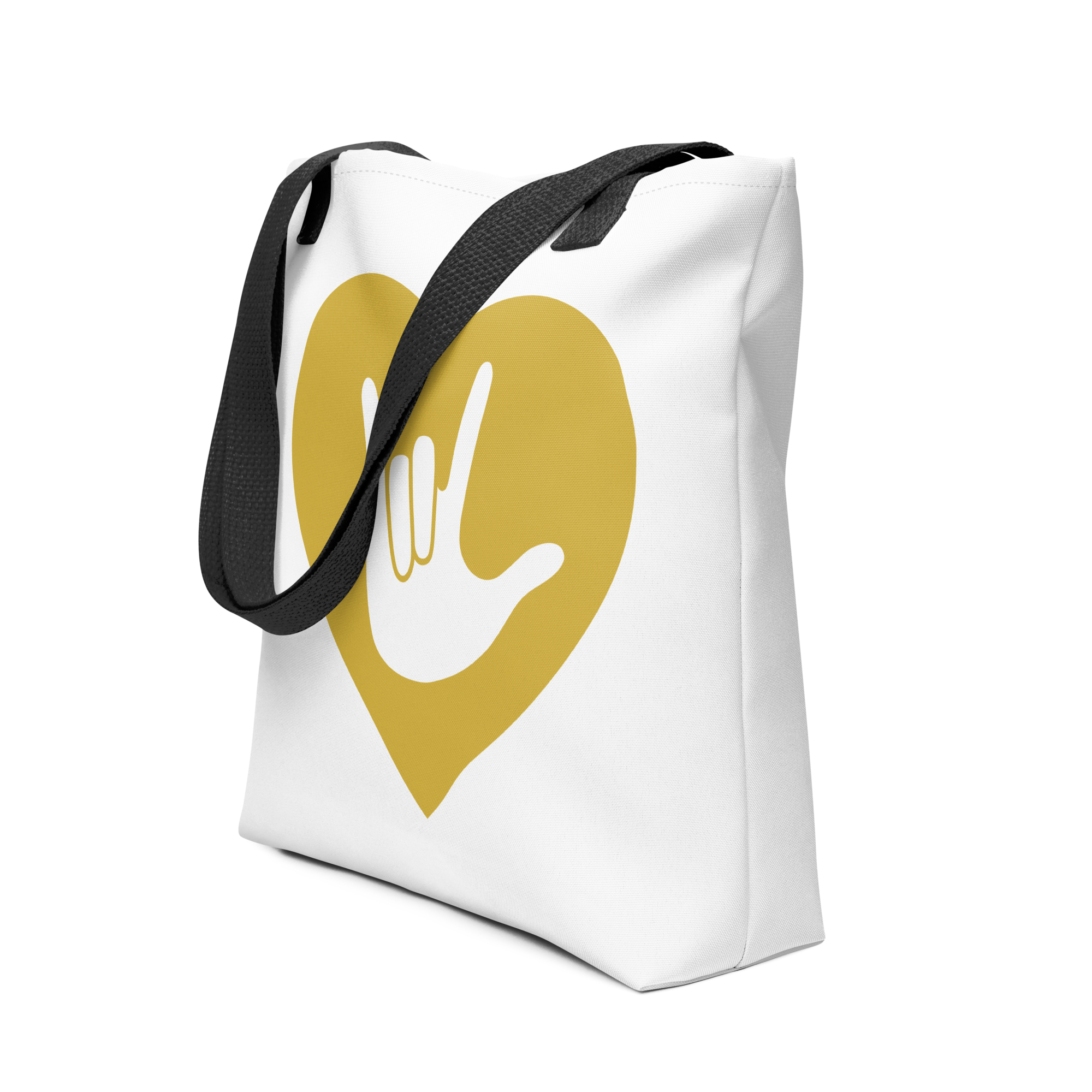 An angled view of a white Tote bag with a black handle and a gold heart with the ASL I love you sign at its center.