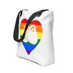 An angled view of a white Tote bag with a black handle and a pride heart with the BSL love sign at its centre.