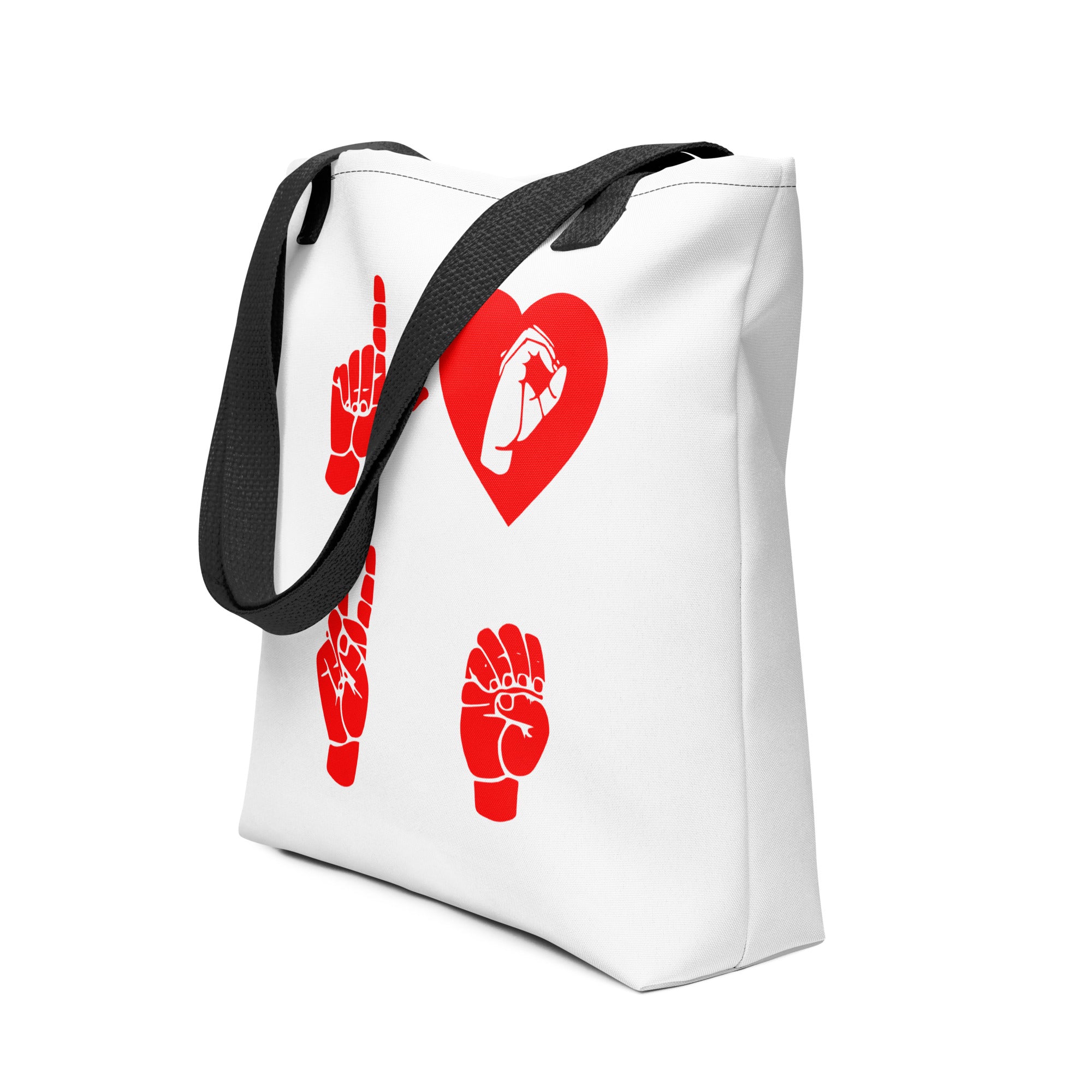 An angled view of a white Tote Bag with black handle showing the word Love in red ASL Fingerspelling with the 'O' embedded in a heart shape