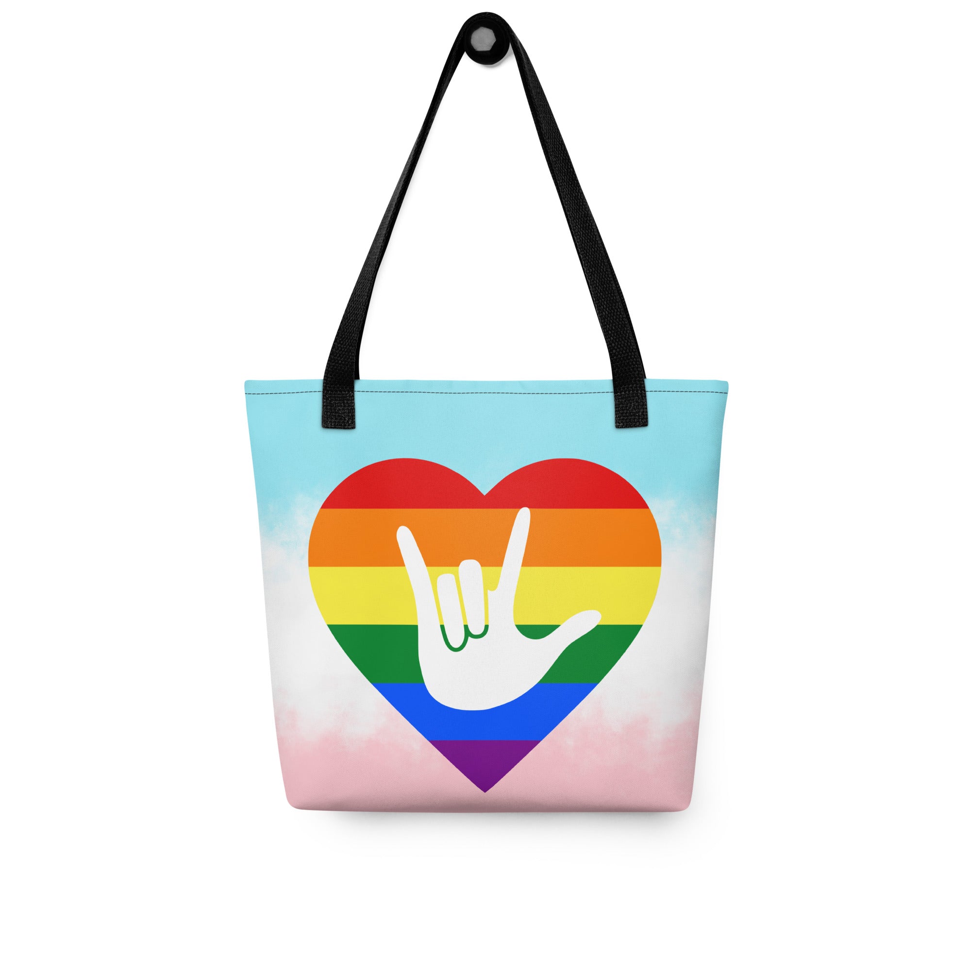 Tote bag with a black handle and a pride heart with the ASL I love you sign at its center.