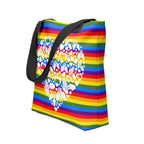 An angled view of a pride rainbow coloured tote bag with a black handle and a white mosaic heart design