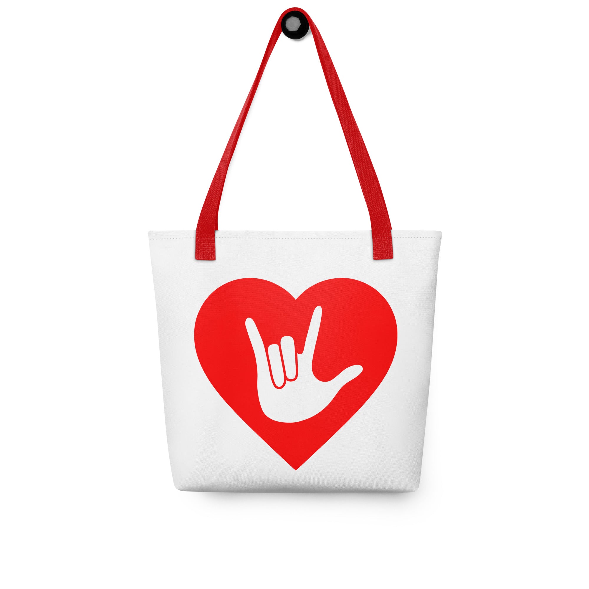 Tote bag with a red handle and a red heart with the ASL I love you sign at its center.