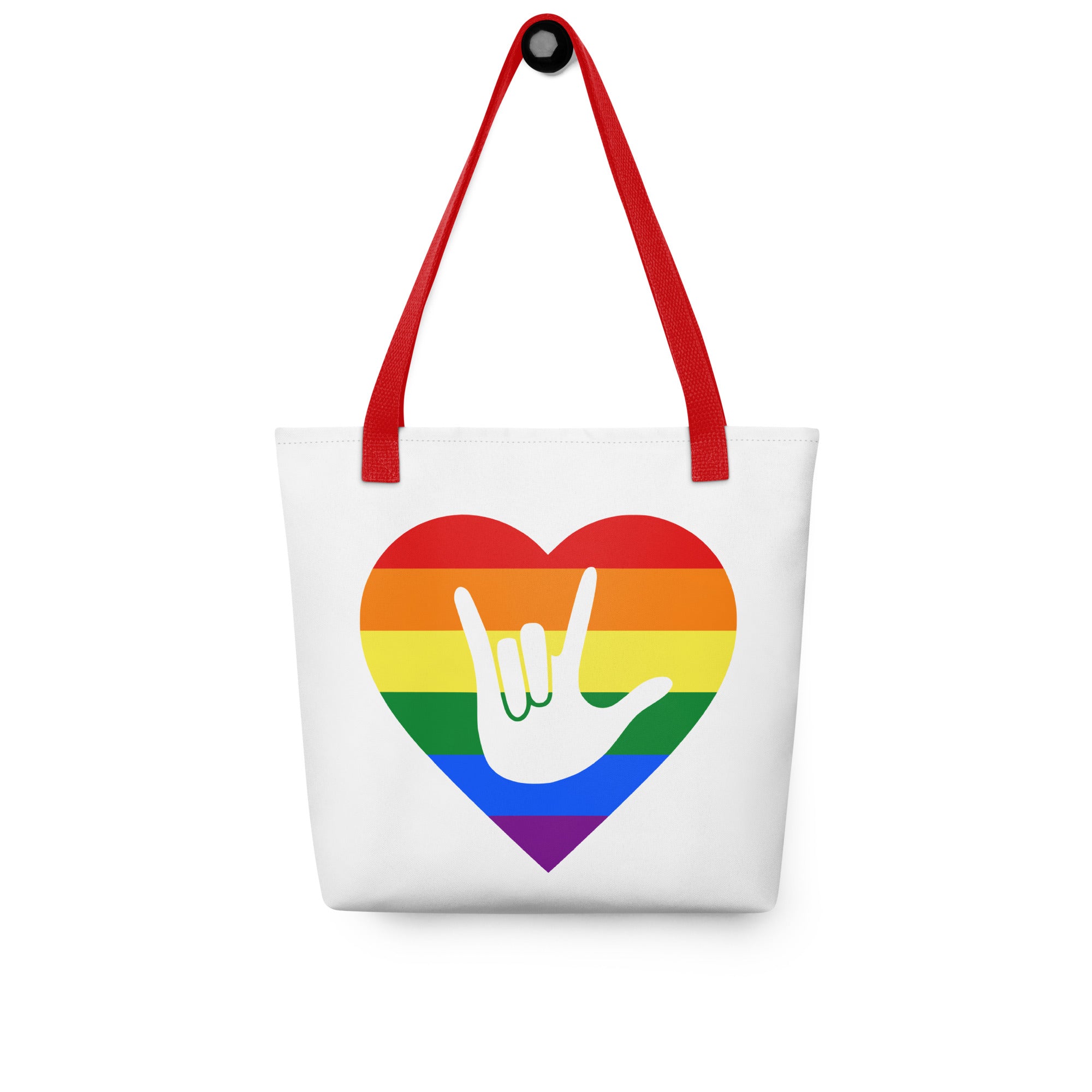 Tote bag with a red handle and a pride heart with the ASL I love you sign at its center.
