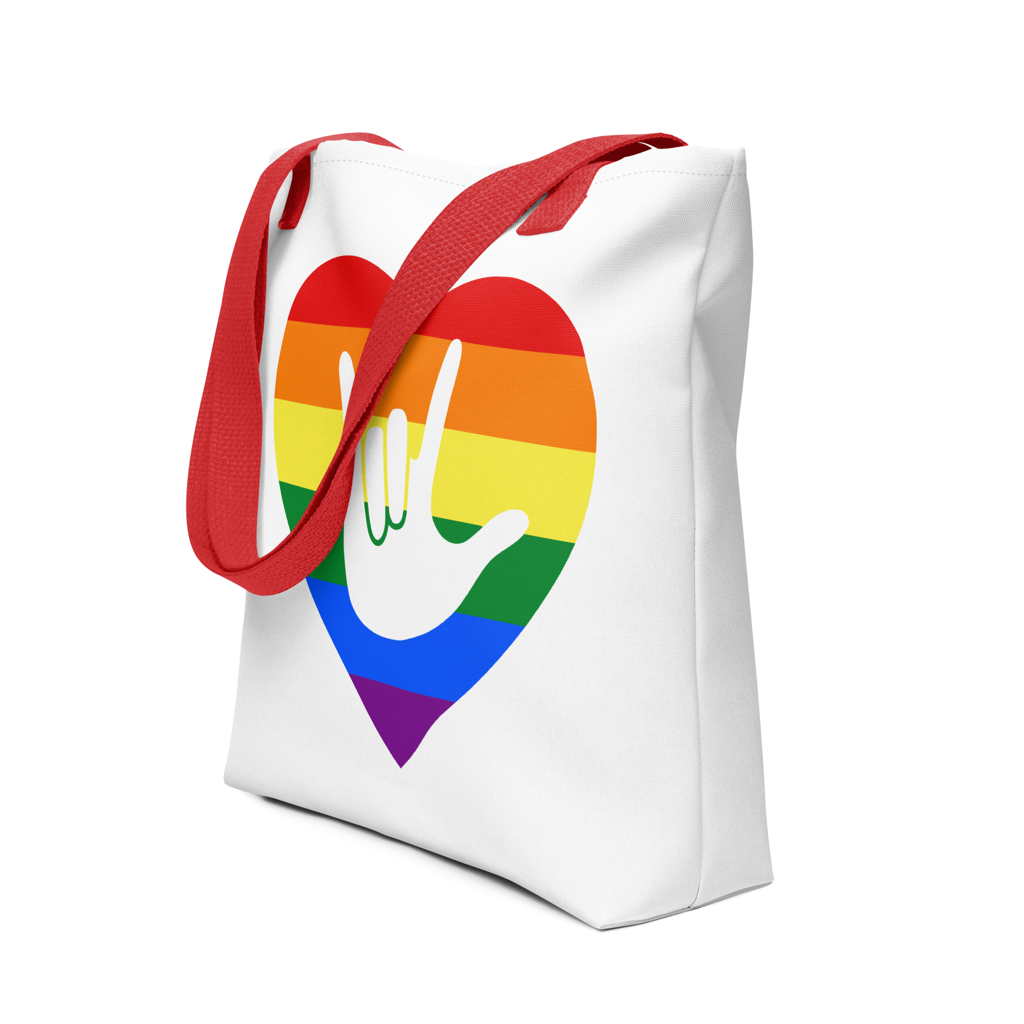 An angled view of a white Tote bag with a red handle and a pride heart with the ASL I love you sign at its center.