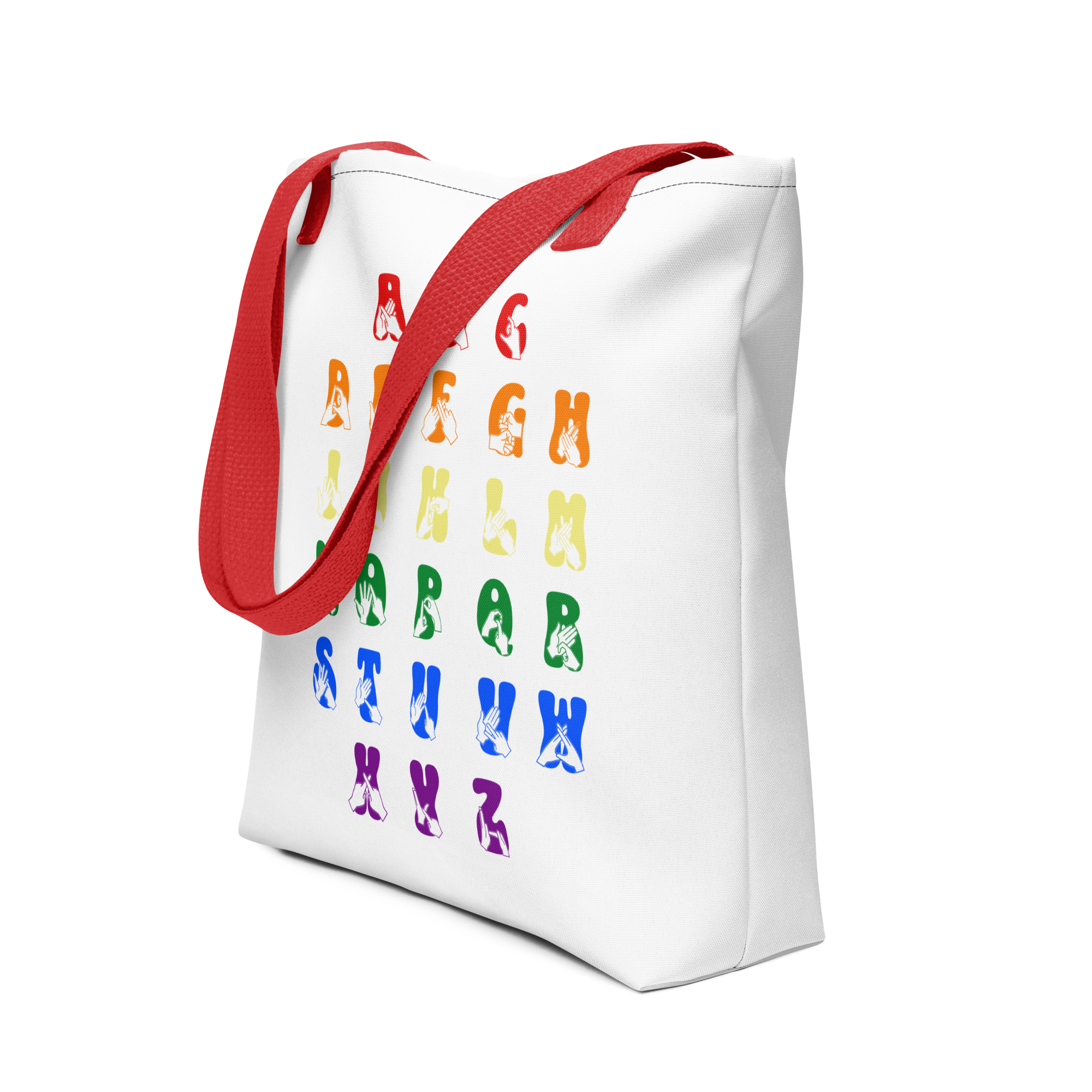 An angled view of a white Tote Bag with red handles showing the BSL Alphabet - Pride Fingerspelling & Text