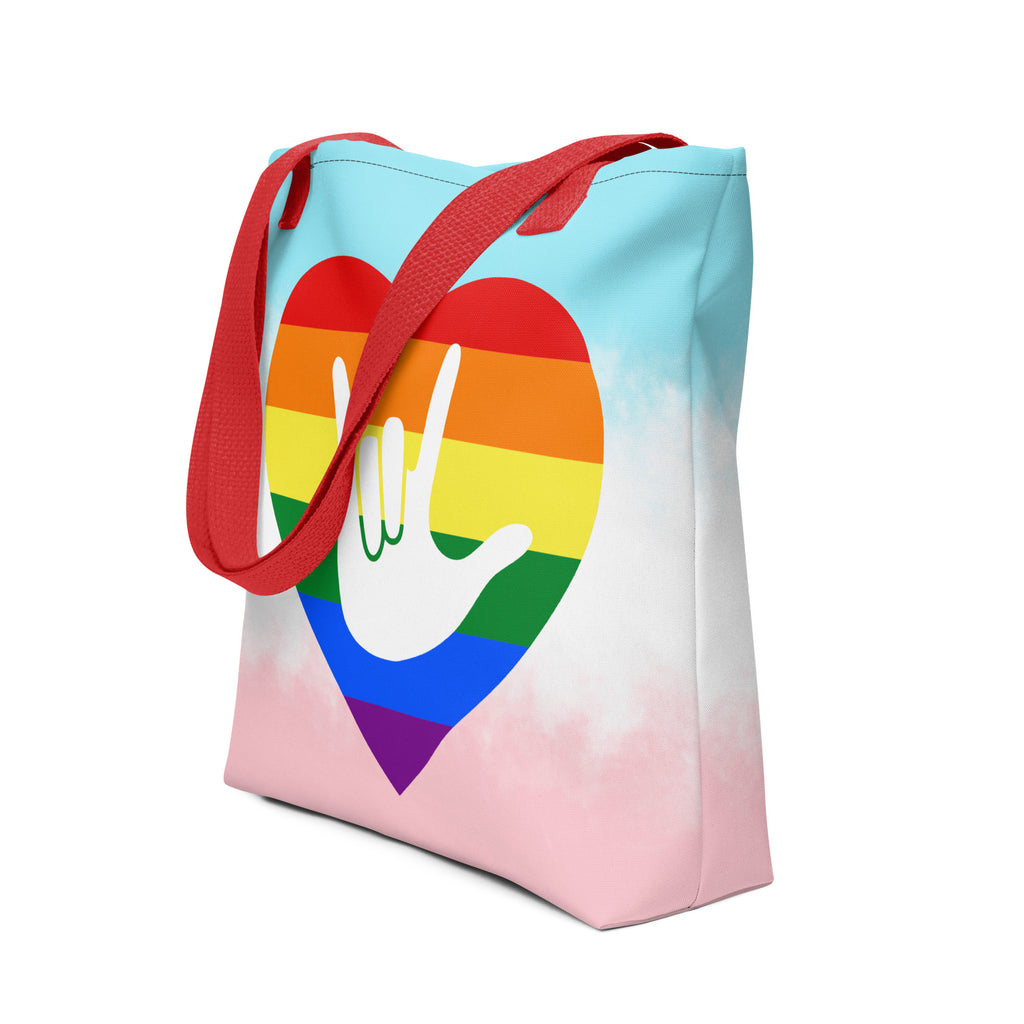 An angled view of a white Tote bag with a red handle and a pride heart with the ASL I love you sign at its center.