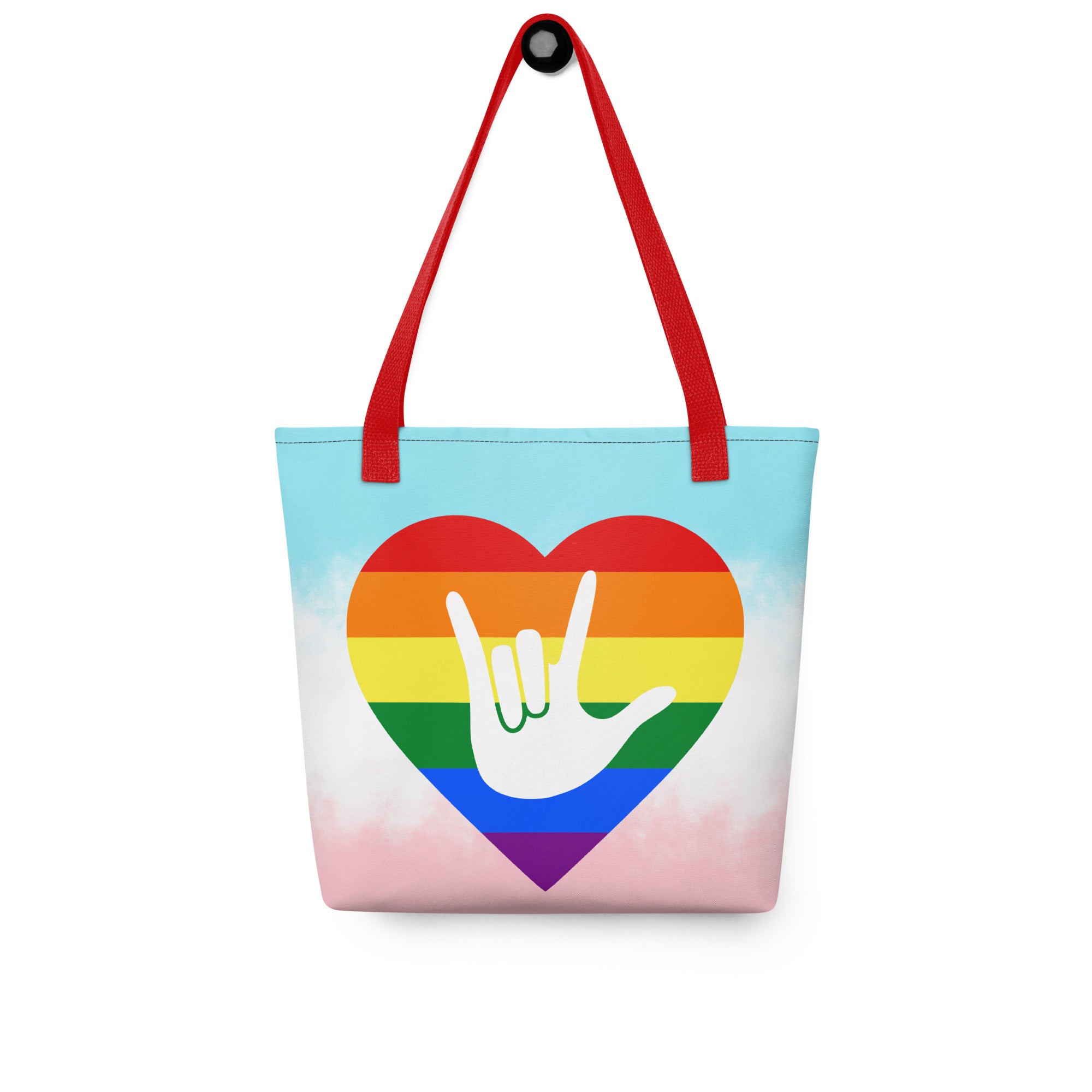 Tote bag with a red handle and a pride heart with the ASL I love you sign at its center.