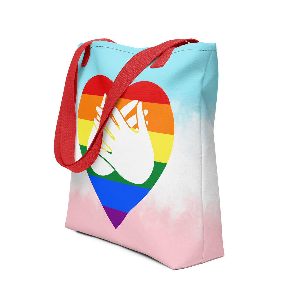 An angled view of a white Tote bag with a red handle and a pride heart with the BSL love sign at its centre.