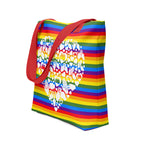 An angled view of a pride rainbow coloured tote bag with a red handle and a white mosaic heart design