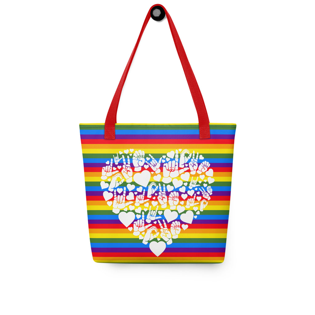 Pride rainbow coloured tote bag with a red handle and a white ASL mosaic design