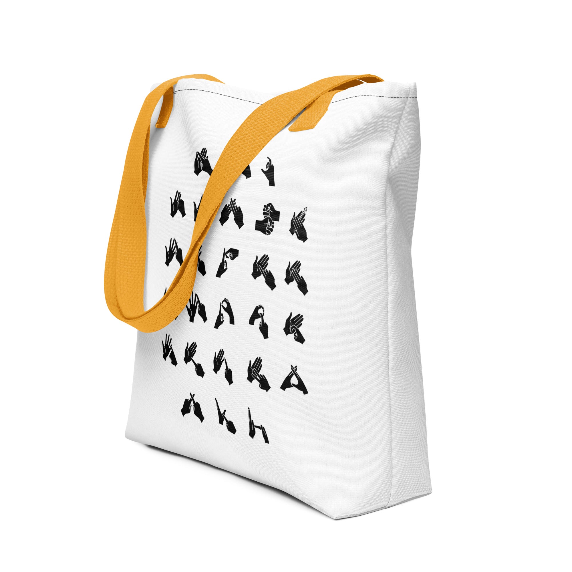 An angled view of a white Tote Bag with a yellow handle showing BSL Alphabet - Black Fingerspelling