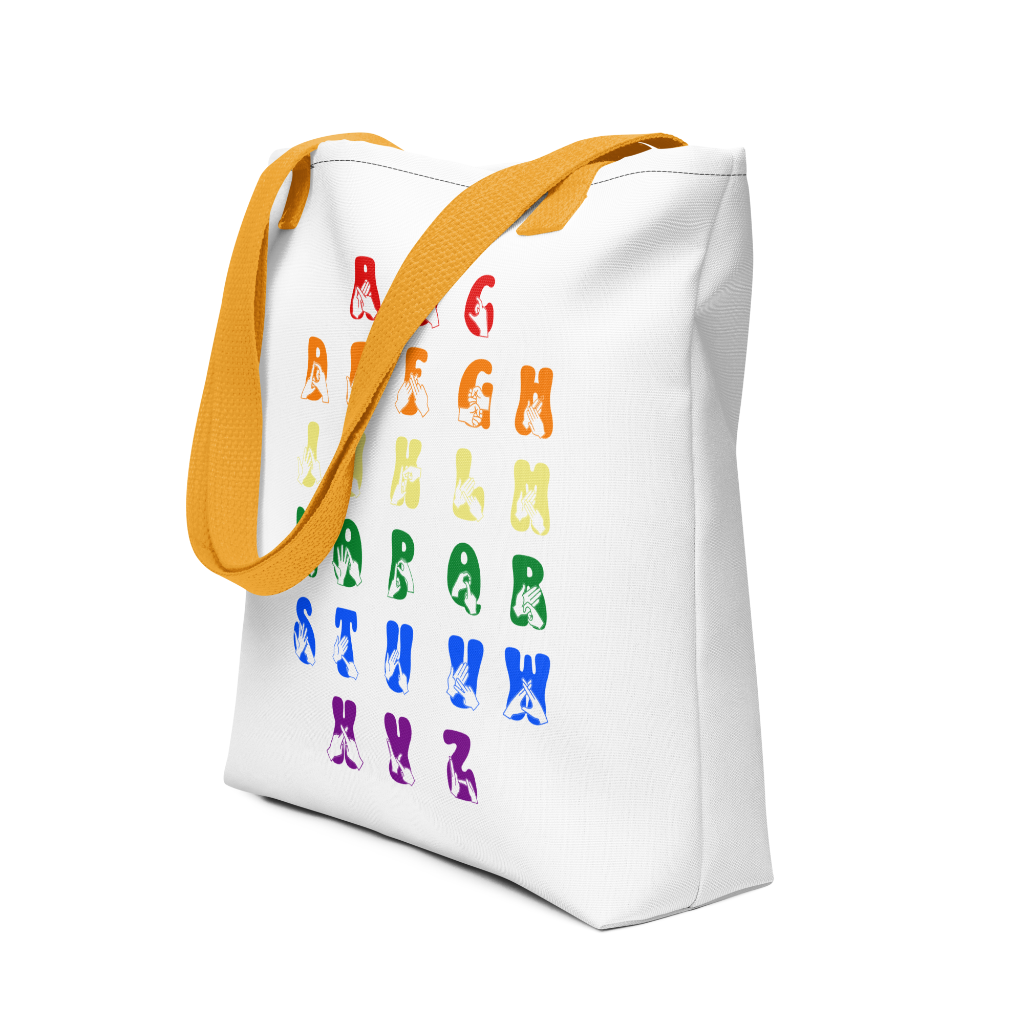 An angled view of a white Tote Bag with yellow handles showing the BSL Alphabet - Pride Fingerspelling & Text