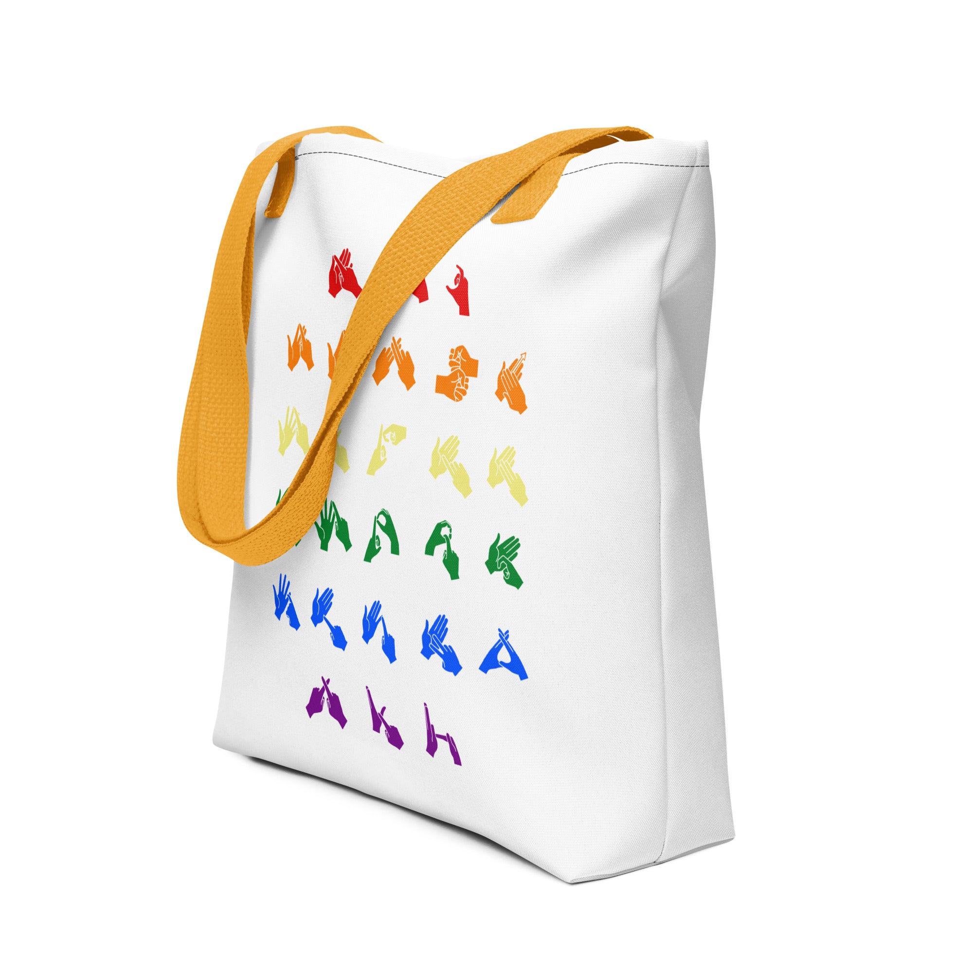 An angled view of a white Tote Bag with yellow handles showing the BSL Alphabet - Pride Fingerspelling