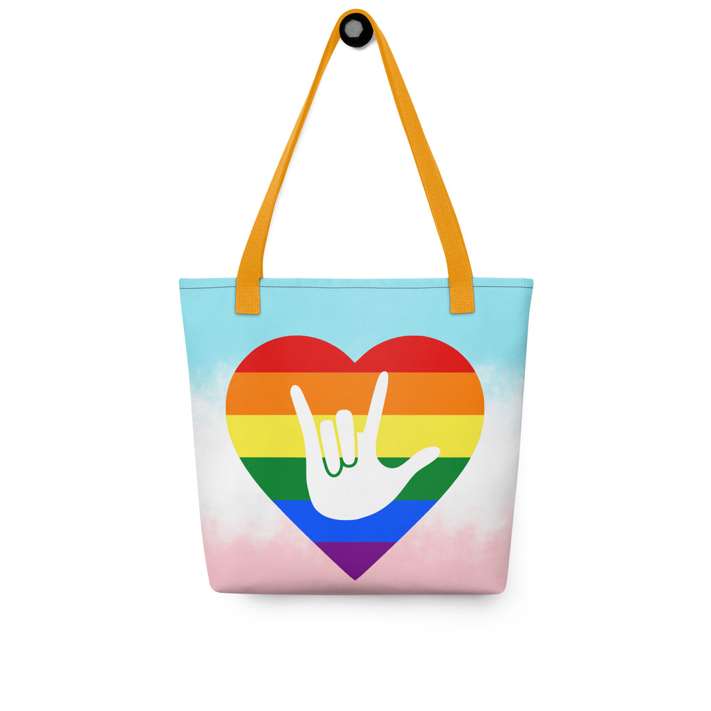 Tote bag with a yellow handle and a pride heart with the ASL I love you sign at its center.