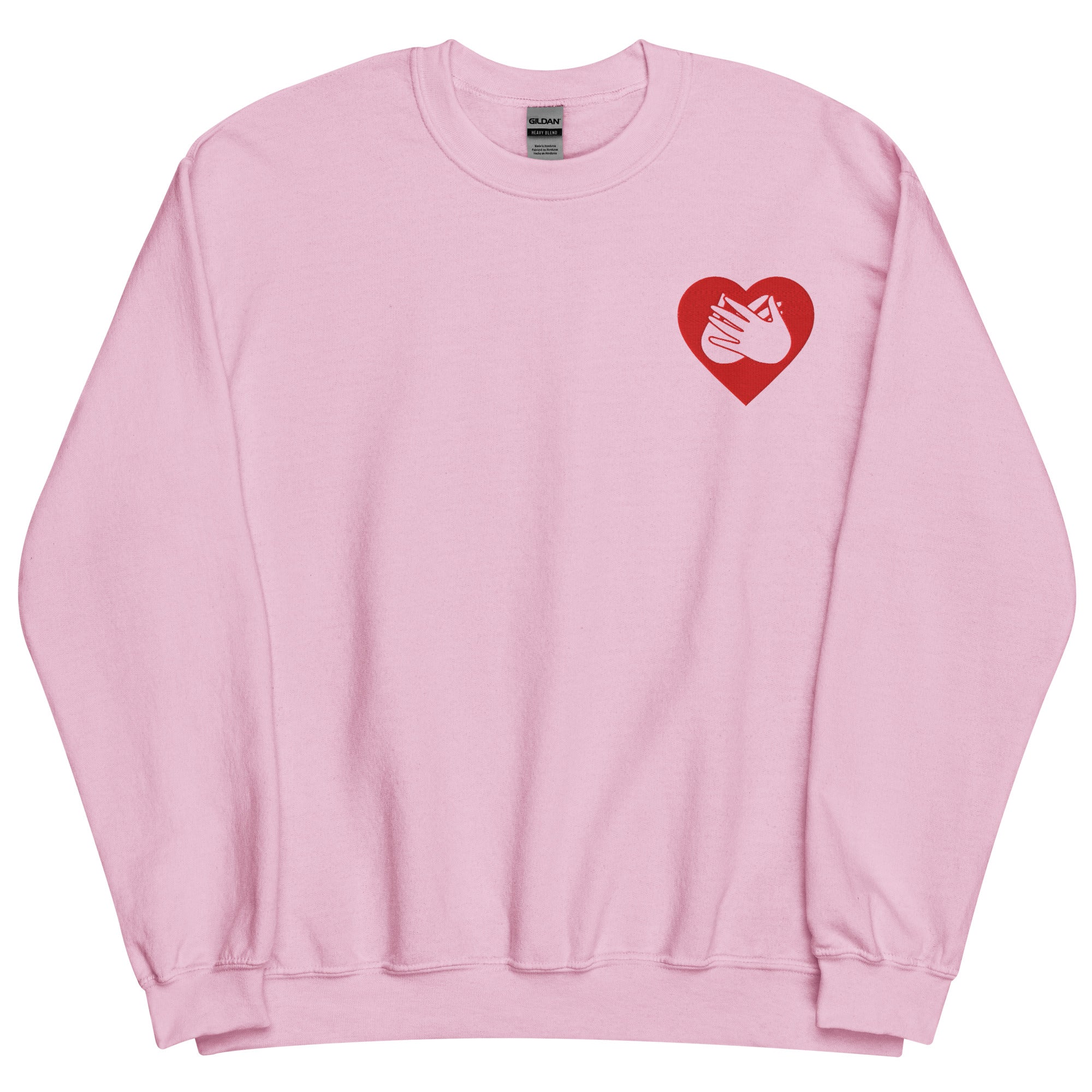Front view of a light pink sweatshirt showing a red coloured heart and the iconic BSL Love sign embedded in it on the left side of the chest