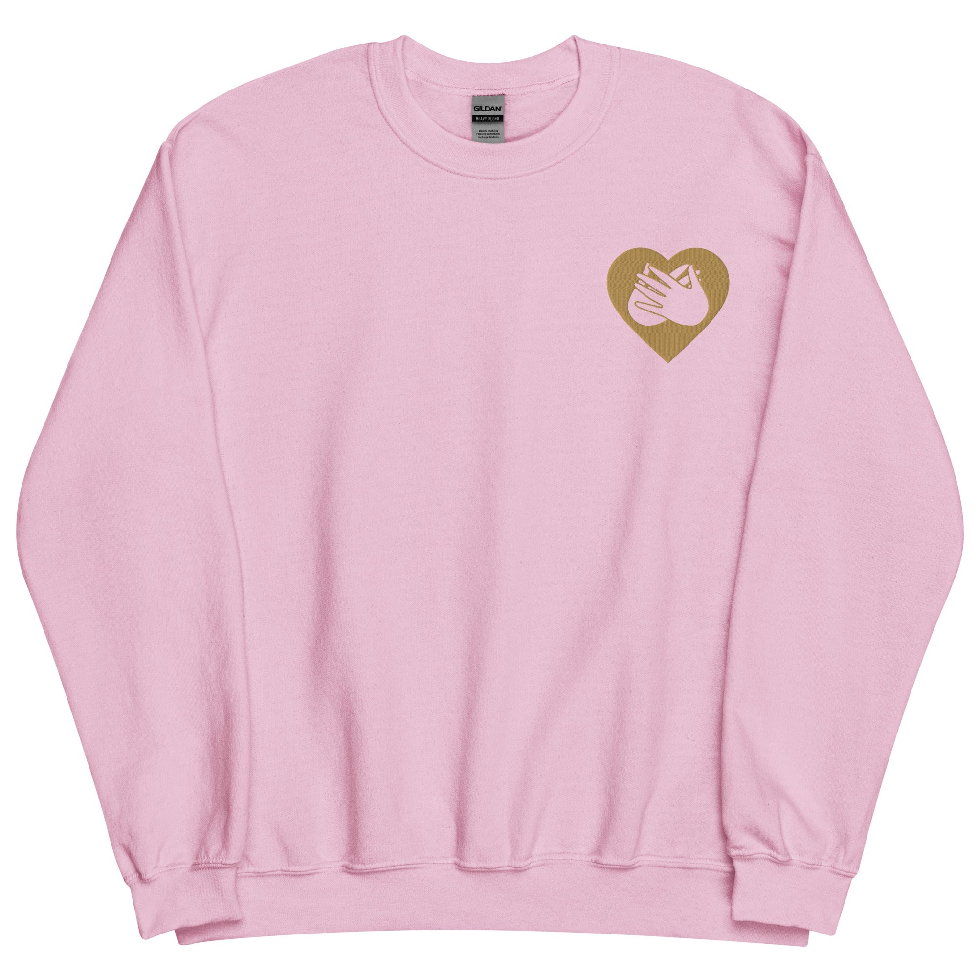 Front view of a light pink sweatshirt showing a gold coloured heart and the iconic BSL Love sign embedded in it on the left side of the chest