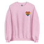 Front view of a light pink sweatshirt showing a pride coloured heart and the iconic BSL Love sign embedded in it on the left side of the chest