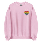 Front view of a light pink sweatshirt showing a pride coloured heart and the iconic ASL I Love You sign embedded in it on the left side of the chest