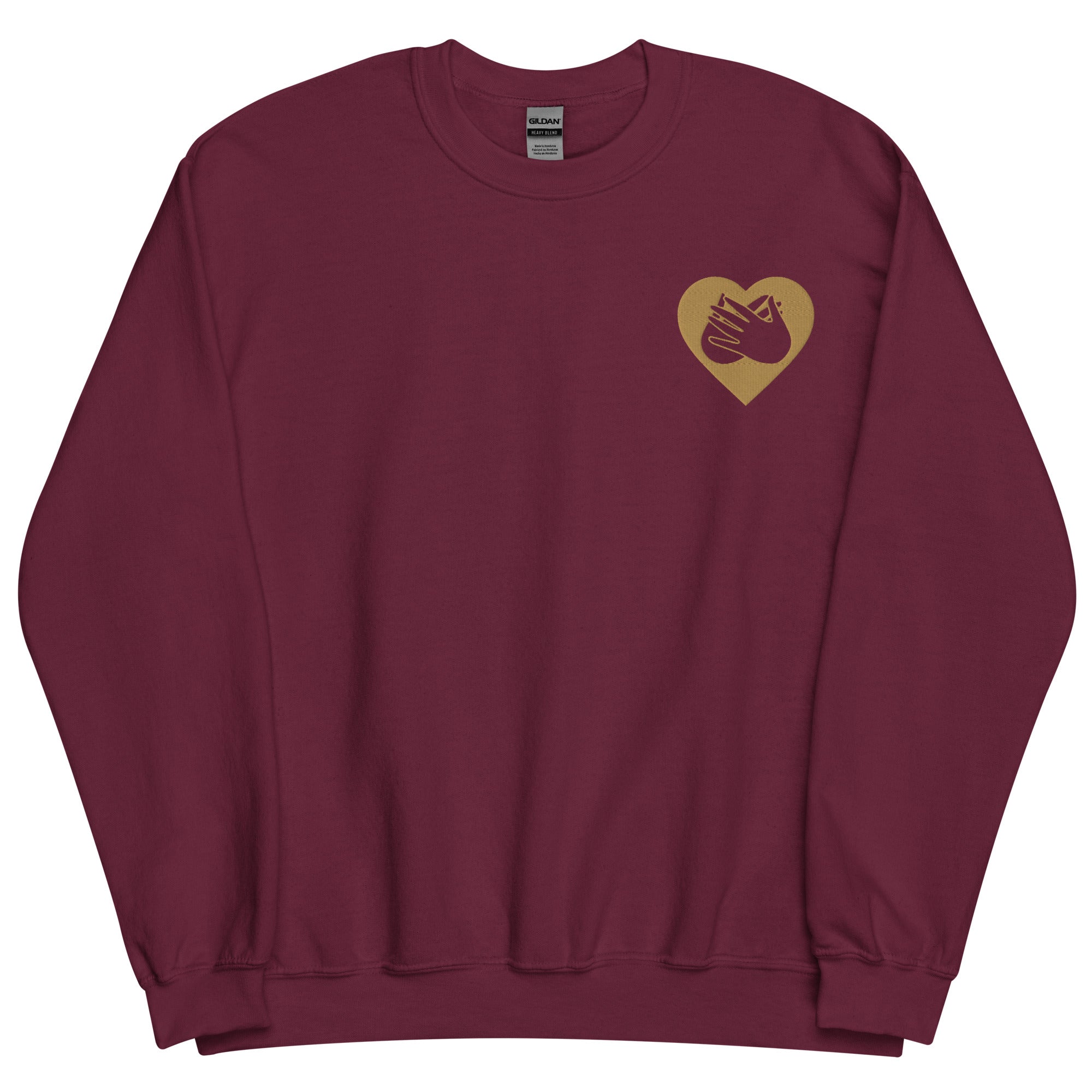Front view of a maroon sweatshirt showing a gold coloured heart and the iconic BSL Love sign embedded in it on the left side of the chest