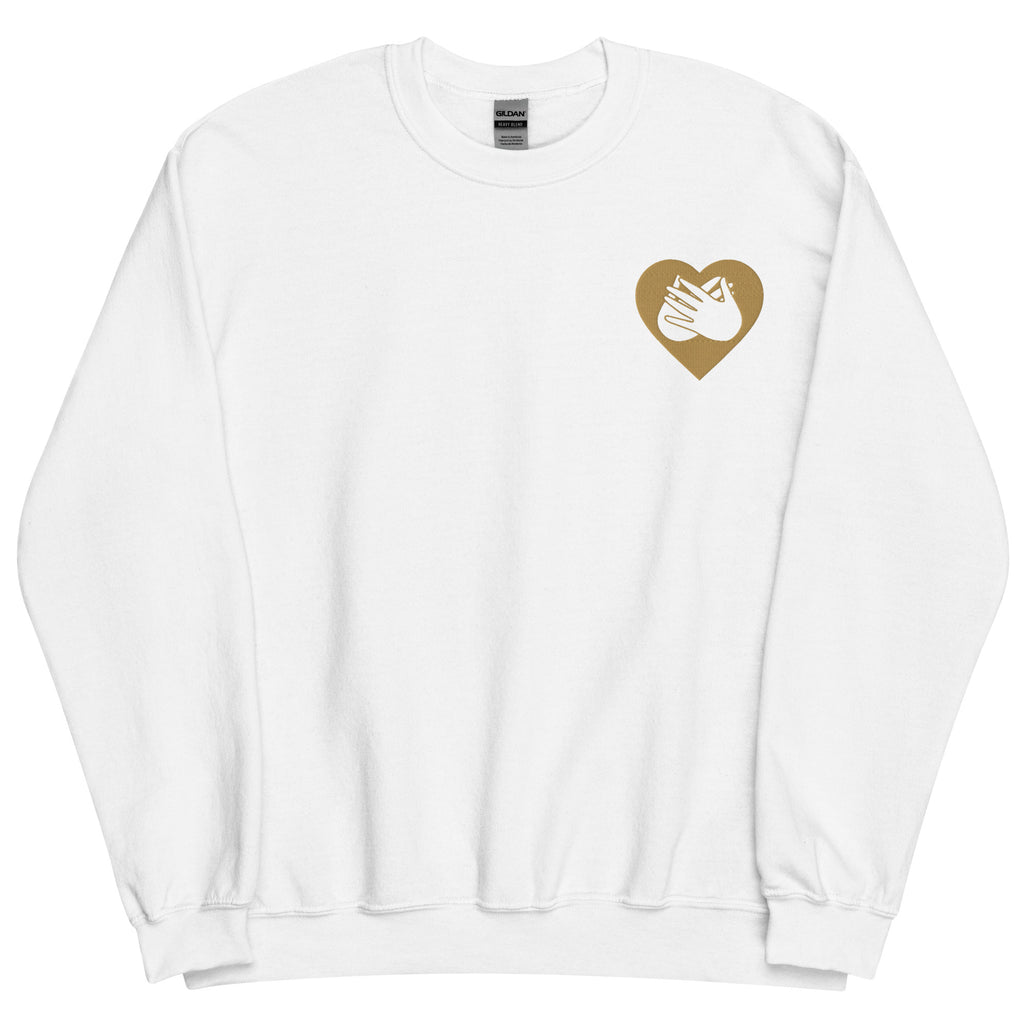 Front view of a white sweatshirt showing a gold coloured heart and the iconic BSL Love sign embedded in it on the left side of the chest