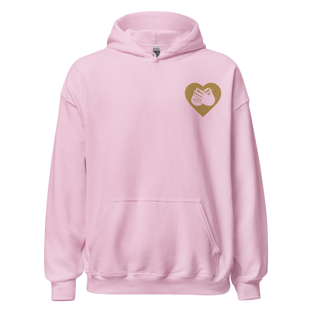 Front view of a light pink hoodie showing a gold coloured heart and the iconic BSL Love sign embedded in it on the left side of the chest