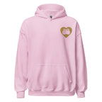 Front view of a light pink hoodie showing a gold coloured heart and the iconic BSL Love sign embedded in it on the left side of the chest