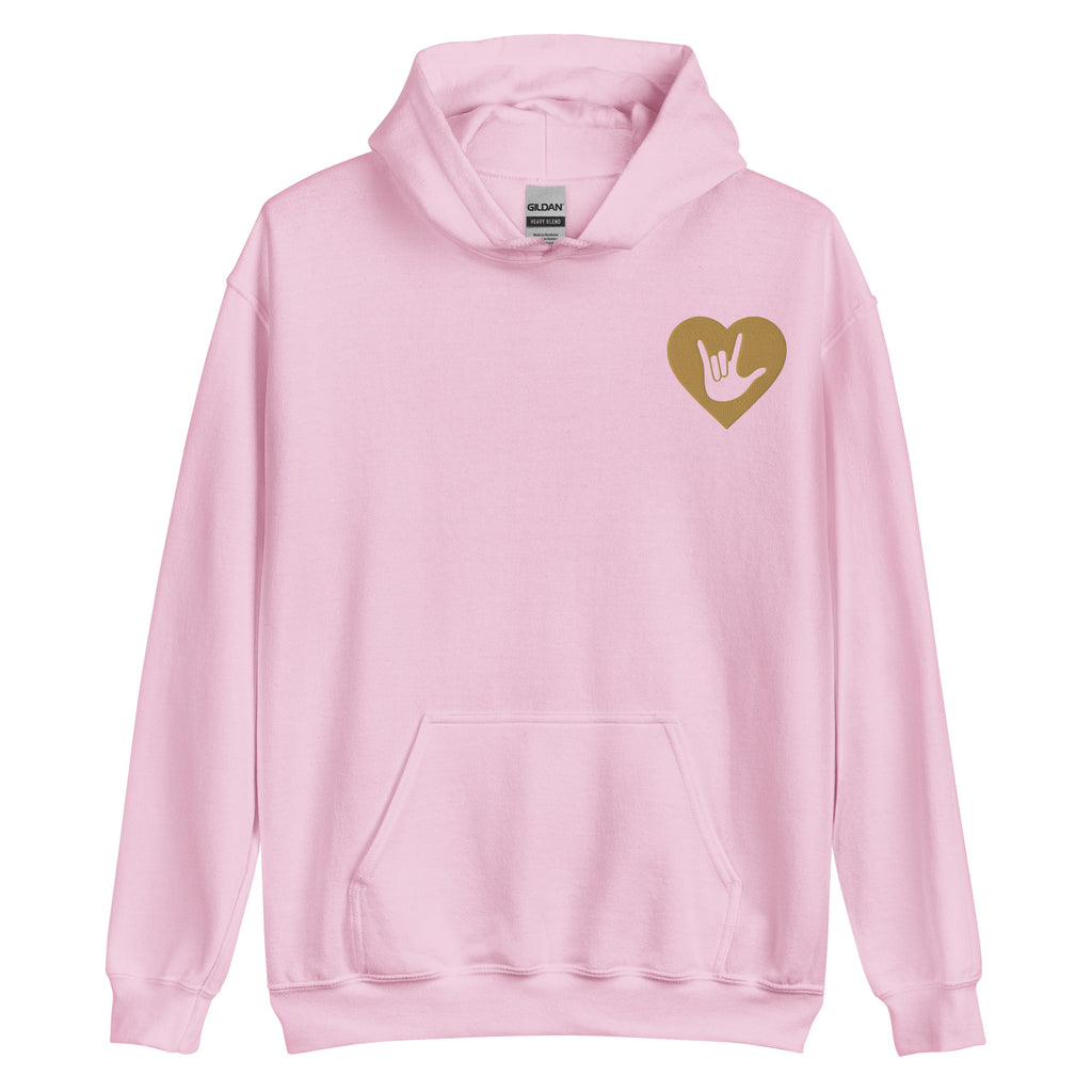 Front view of a light pink hoodie showing a gold coloured heart and the iconic ASL I Love You sign embedded in it on the left side of the chest