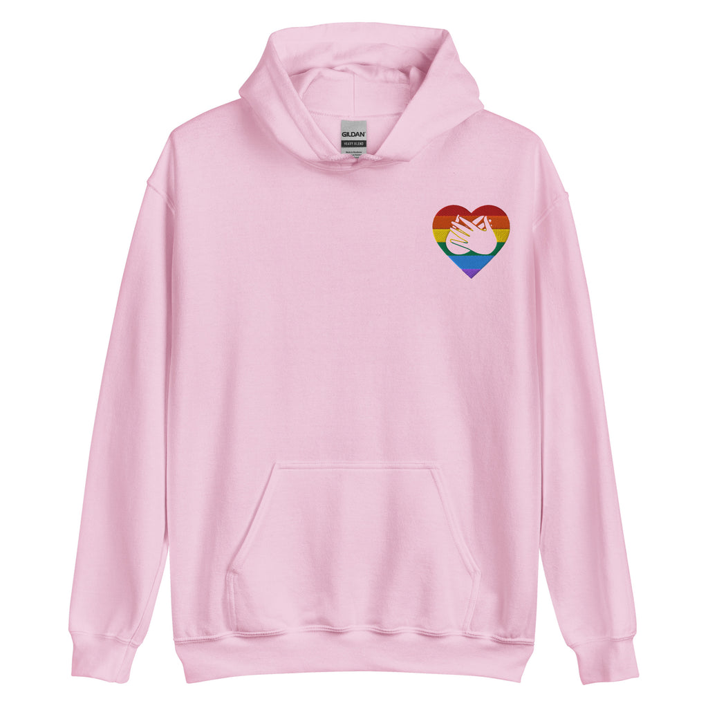 Front view of a light pink hoodie showing a pride coloured heart and the iconic BSL Love sign embedded in it on the left side of the chest