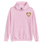 Front view of a light pink hoodie showing a gold coloured heart and the iconic BSL Love sign embedded in it on the left side of the chest