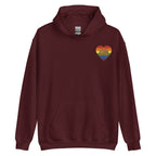 Front view of a maroon hoodie showing a pride coloured heart and the iconic BSL Love sign embedded in it on the left side of the chest