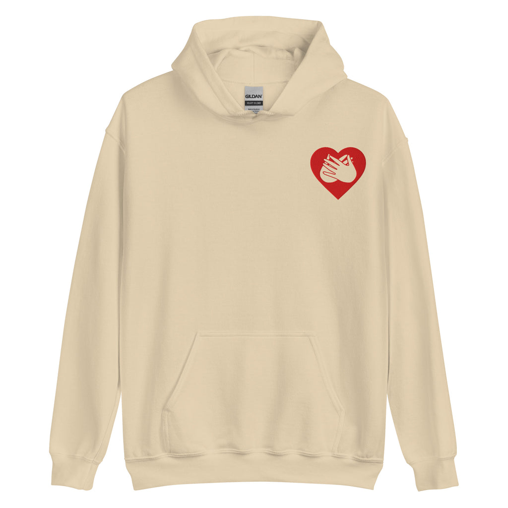 Front view of a sand hoodie showing a red coloured heart and the iconic BSL Love sign embedded in it on the left side of the chest