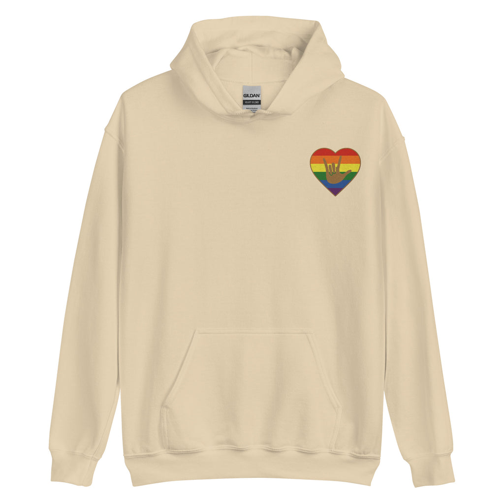 Front view of a sand hoodie showing a pride colored heart and the iconic ASL I Love You sign embedded in it on the left side of the chest