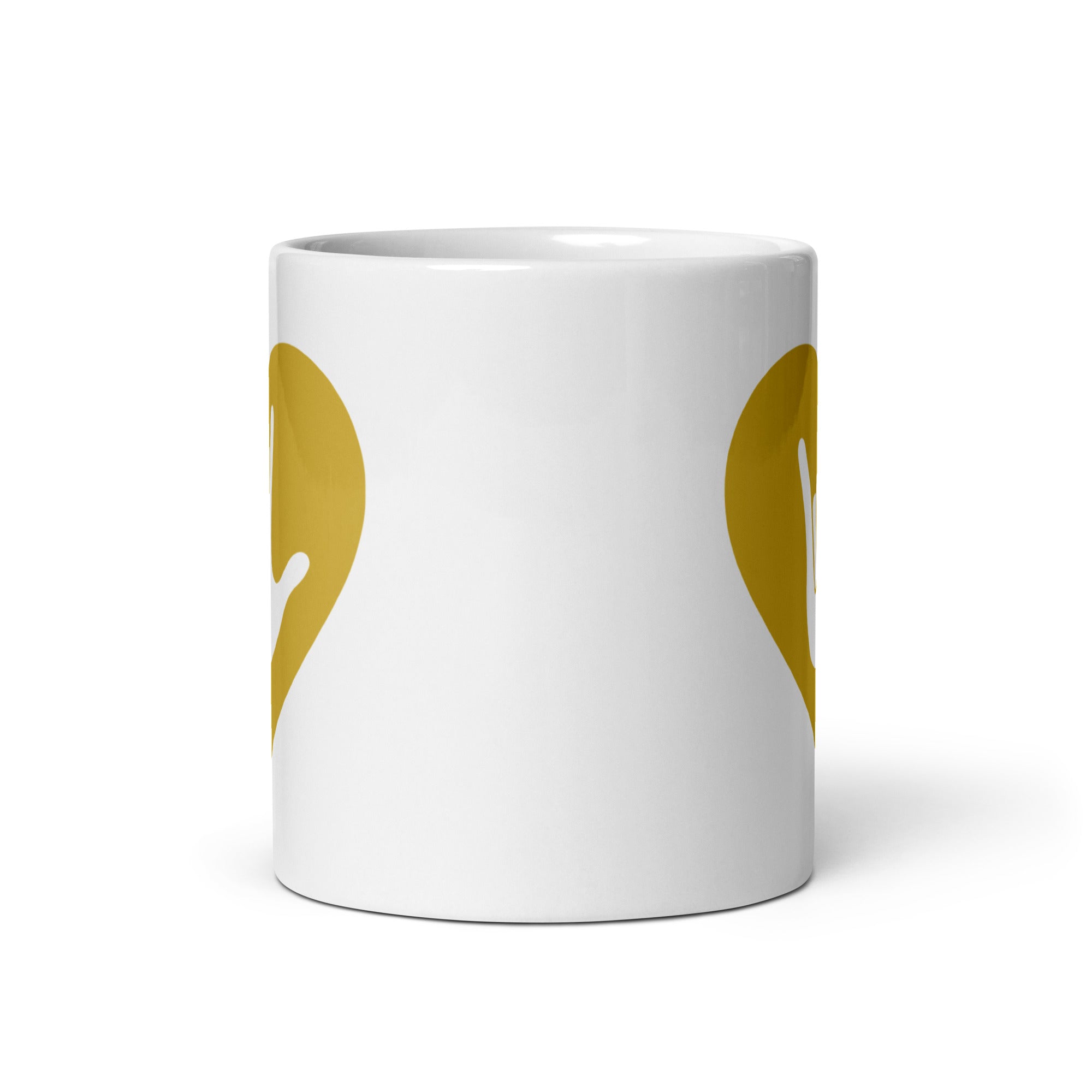 White mug with no handle visible, showing part of the gold coloured heart design on each side.