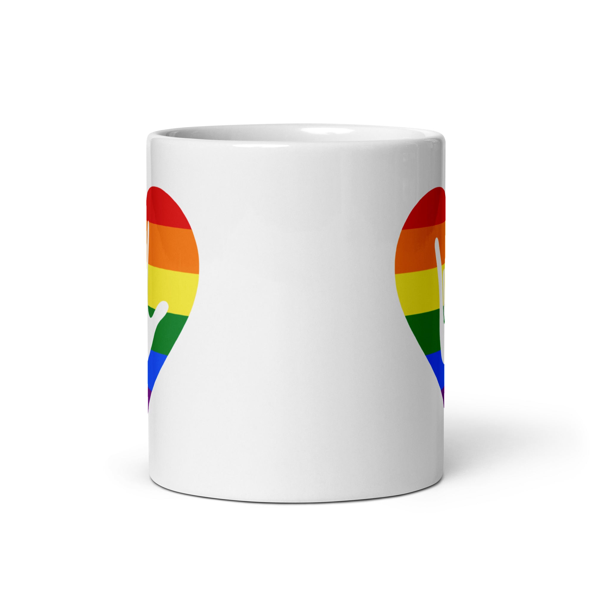 White mug with no handle visible, showing part of the pride coloured heart design on each side.