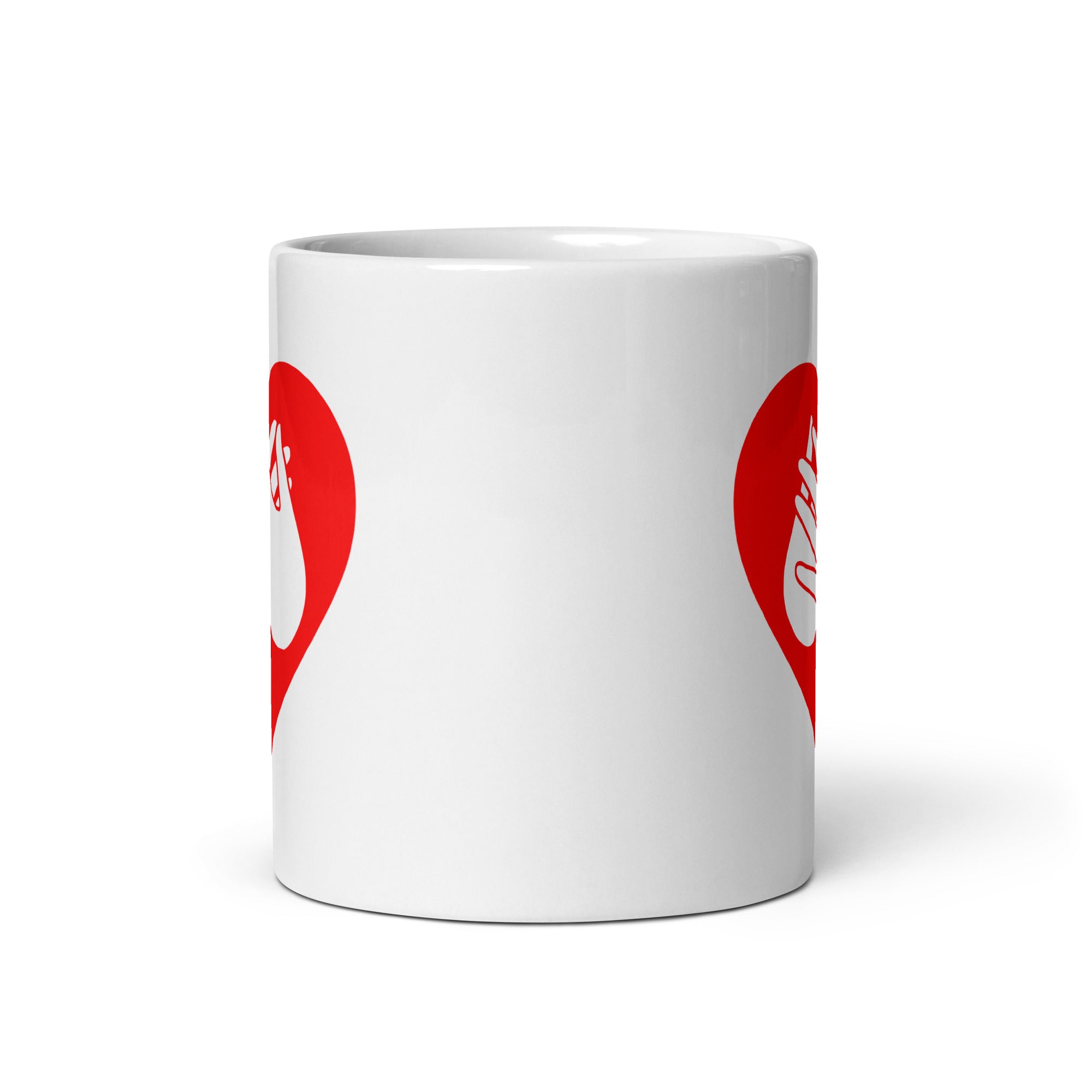 White mug with no handle visible, showing part of the red coloured heart design on each side.