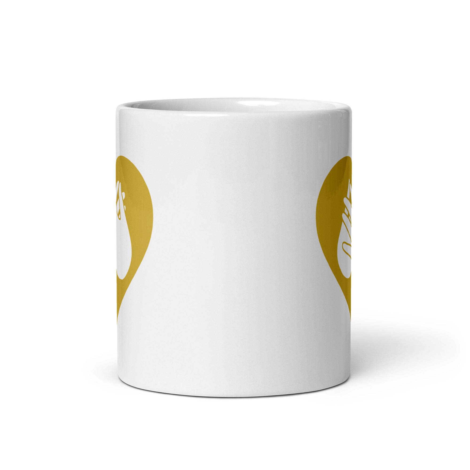 White mug with no handle visible, showing part of the gold coloured heart design on each side.