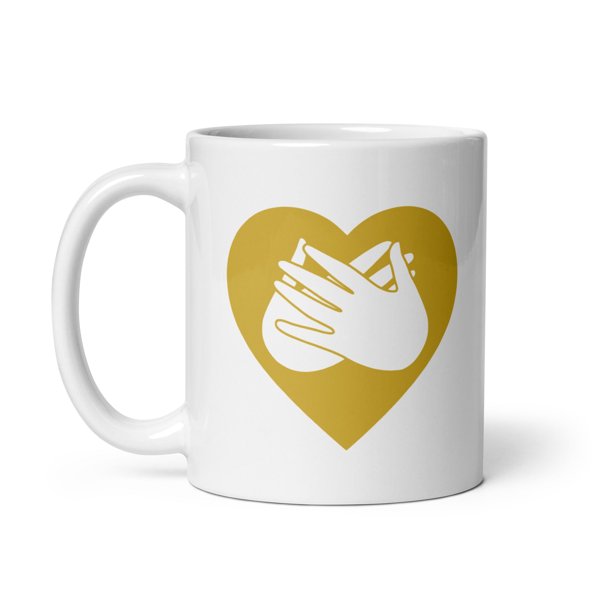 White mug with a gold coloured heart design featuring the BSL sign for Love embedded in it. The mug handle is on the left hand side of the mug.